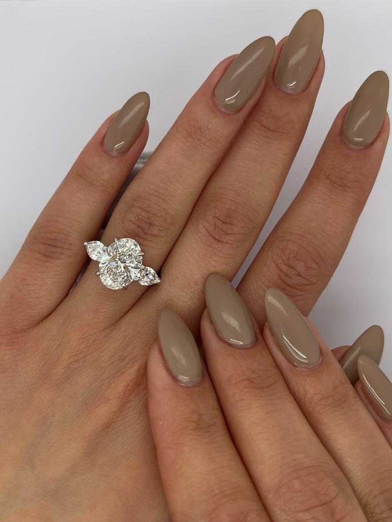 Buy three-stone ring with matching band, Discounted three-stone engagement rings, Luxury three-stone engagement rings, Unique three-stone diamond rings.