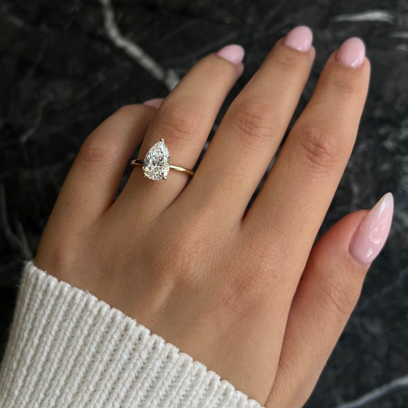 Pear swirl diamond ring, Pear unique diamond ring, Pear traditional diamond ring, Pear contemporary diamond ring, Pear minimalist diamond ring, Pear intricate diamond ring, Pear bold diamond ring, Pear delicate diamond ring,