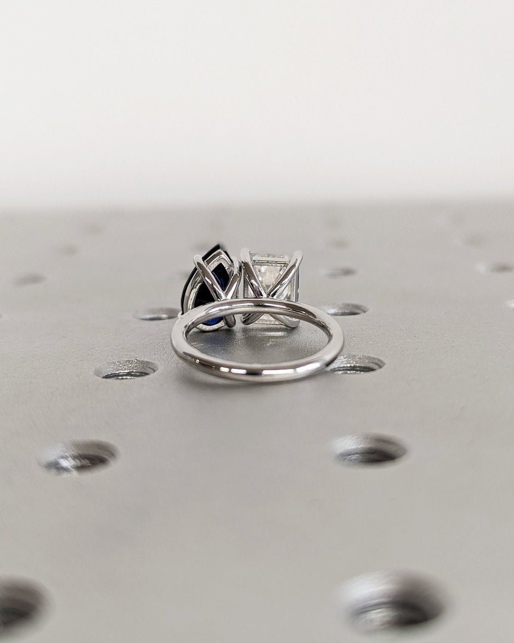 Toi Et Moi engagement ring with sapphire and emerald cut stones
