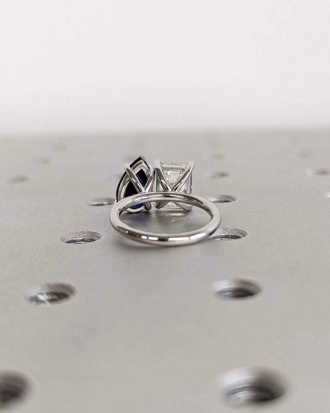Toi Et Moi engagement ring with sapphire and emerald cut stones

