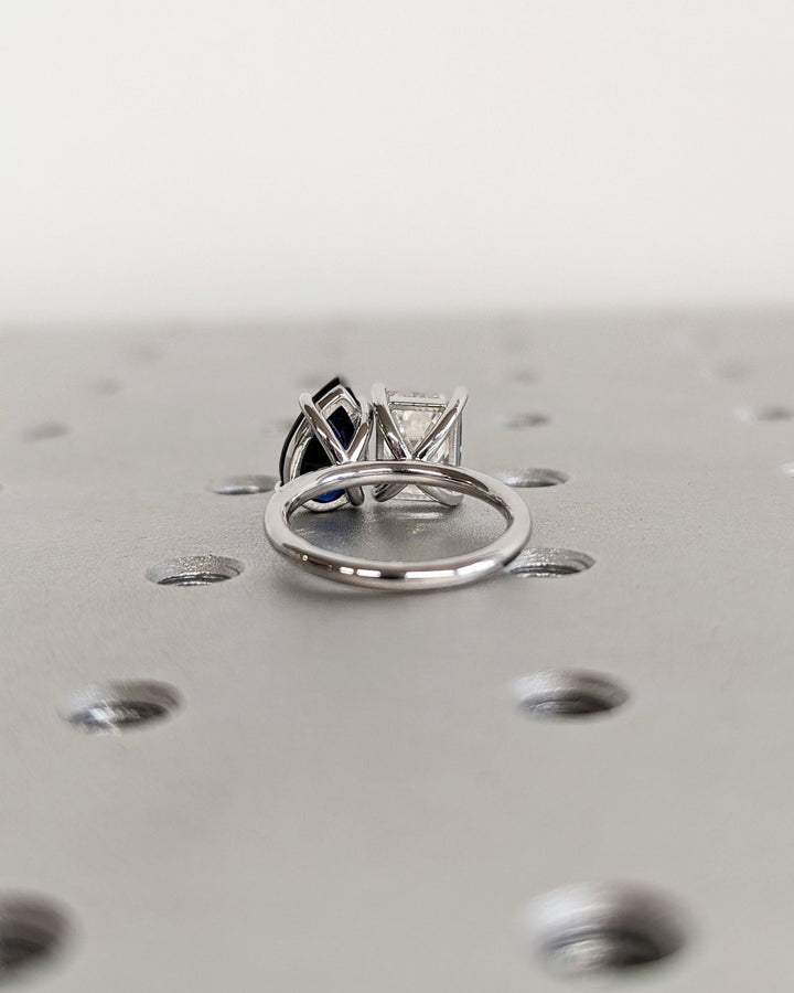 Toi Et Moi engagement ring with sapphire and emerald cut stones
