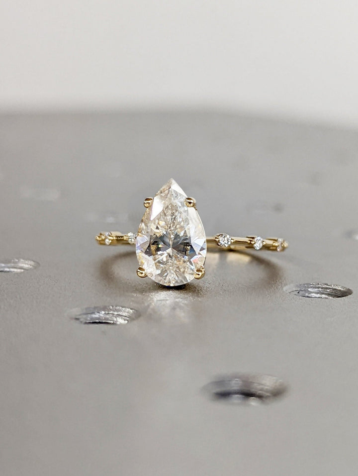 Lab grown diamond engagement ring featuring pear center stone