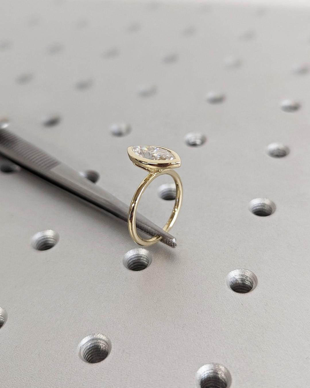 Brilliant marquise shaped diamond ring with bezel setting