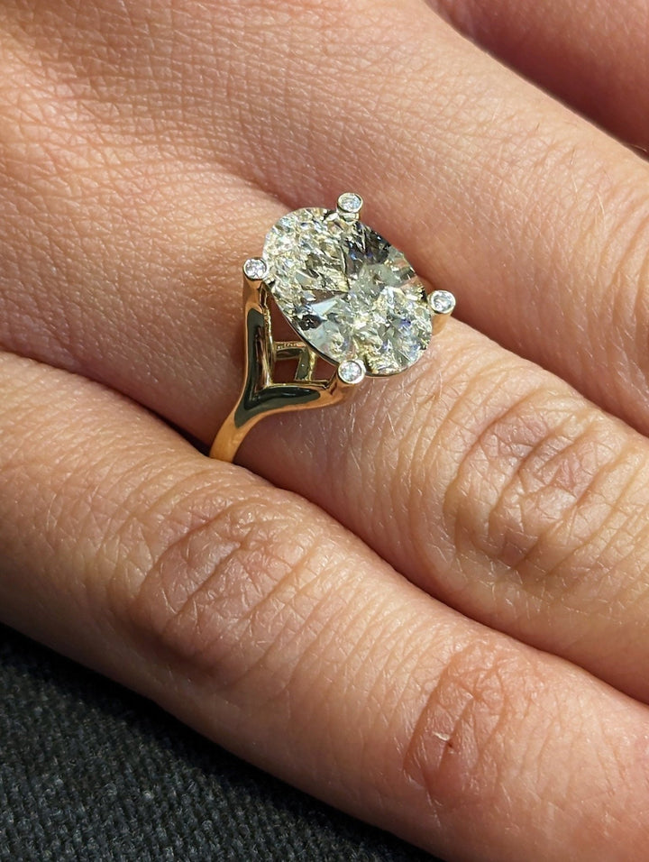 Luxury diamond ring with oval brilliant center stone
