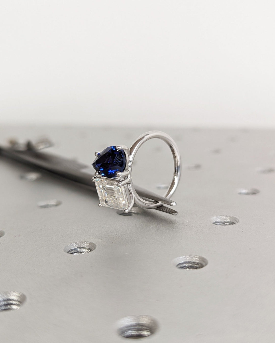 Luxury dual stone engagement ring featuring sapphire and emerald cut