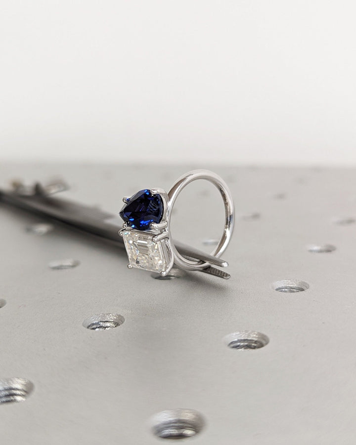 Luxury dual stone engagement ring featuring sapphire and emerald cut