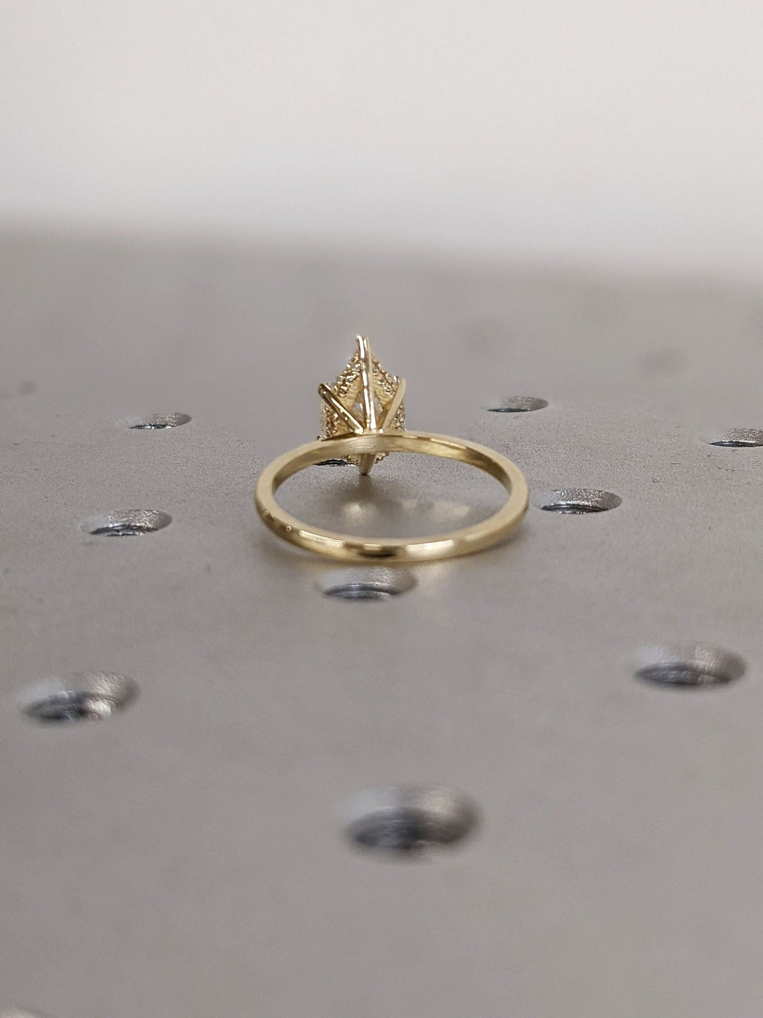 Brilliant pear shaped diamond ring with hidden halo detail