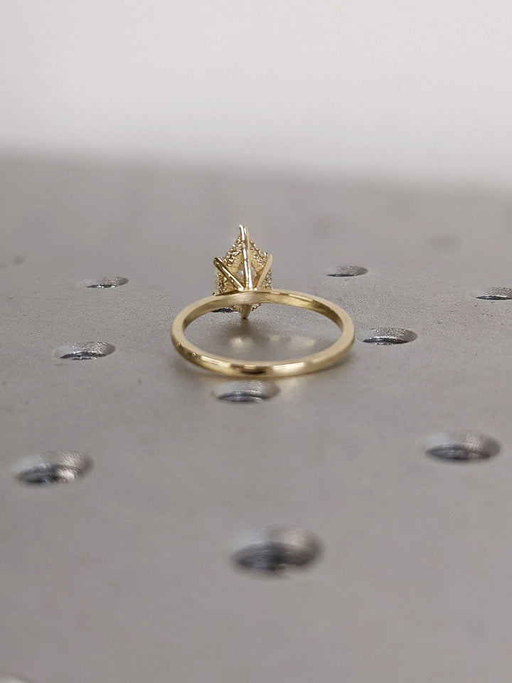Brilliant pear shaped diamond ring with hidden halo detail