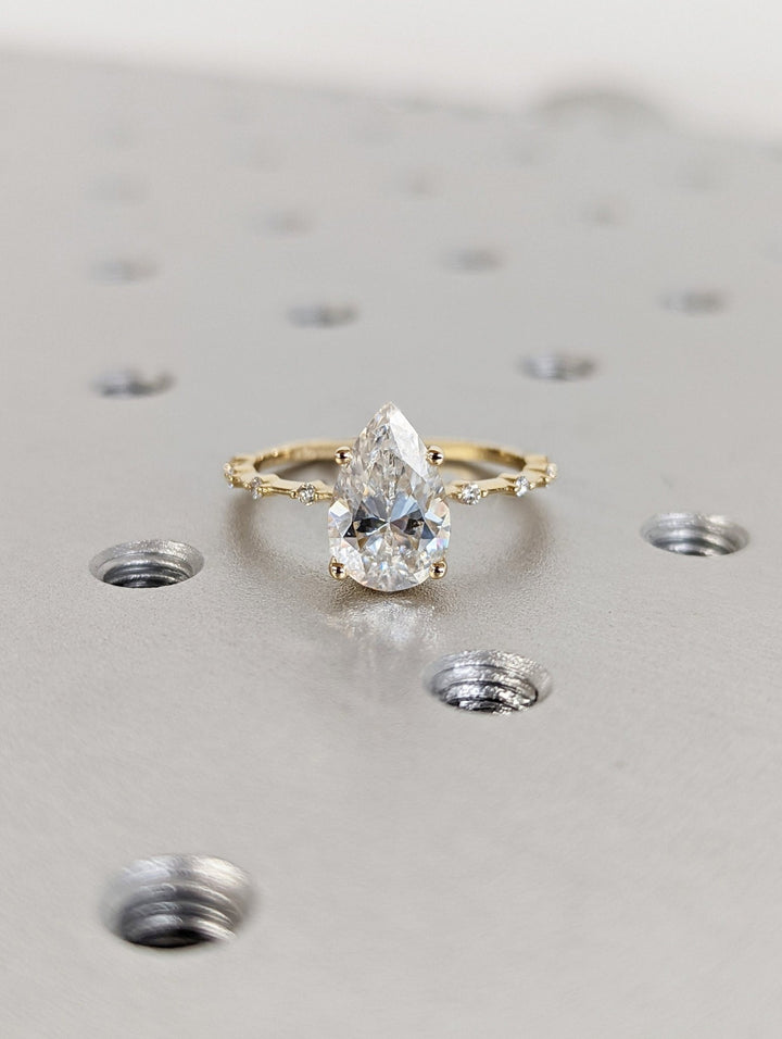 Brilliant pear shaped lab diamond ring with petite pave accents