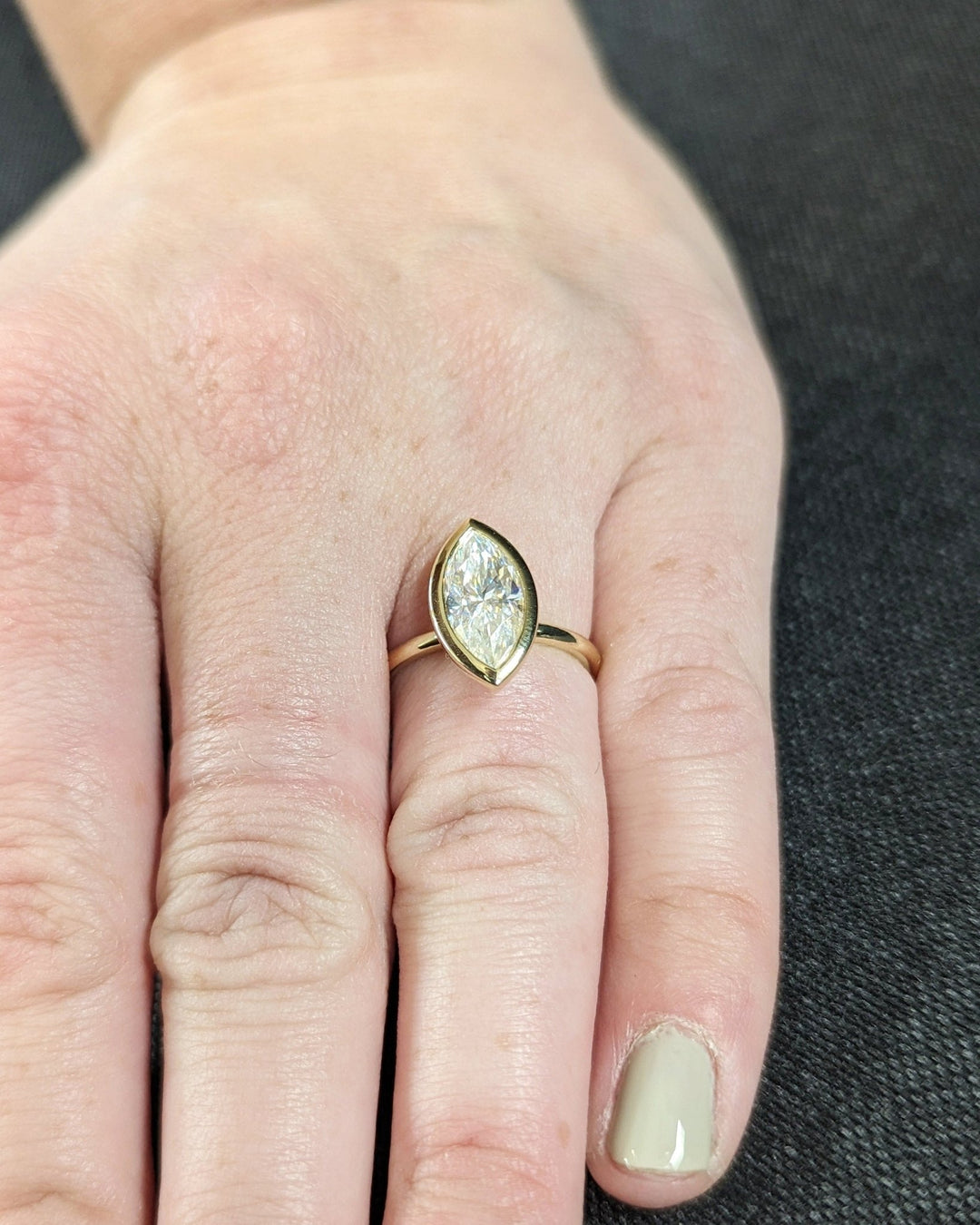 Elegant proposal ring with marquise cut bezel design