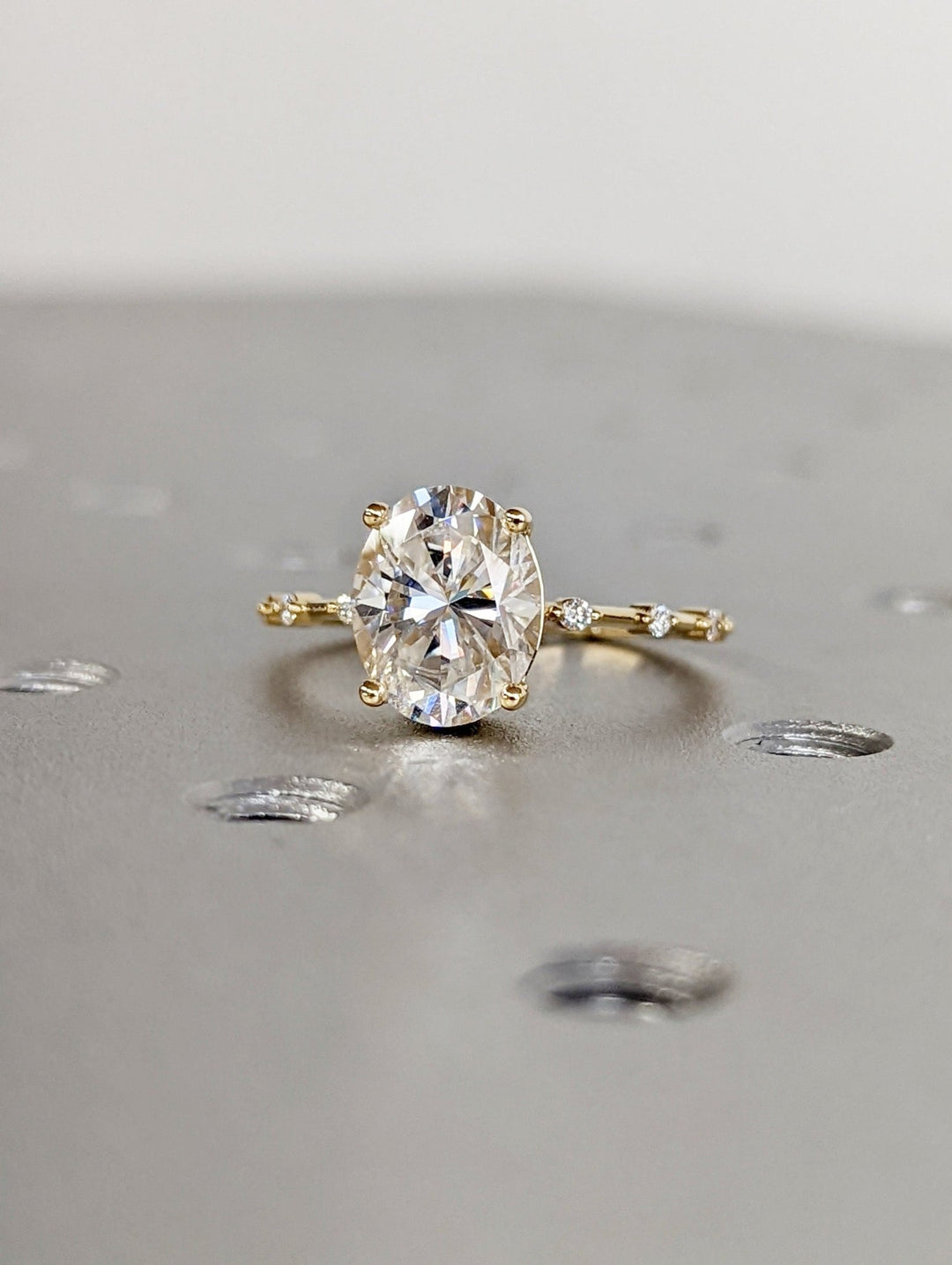 Elegant oval diamond proposal ring with sparkling accents