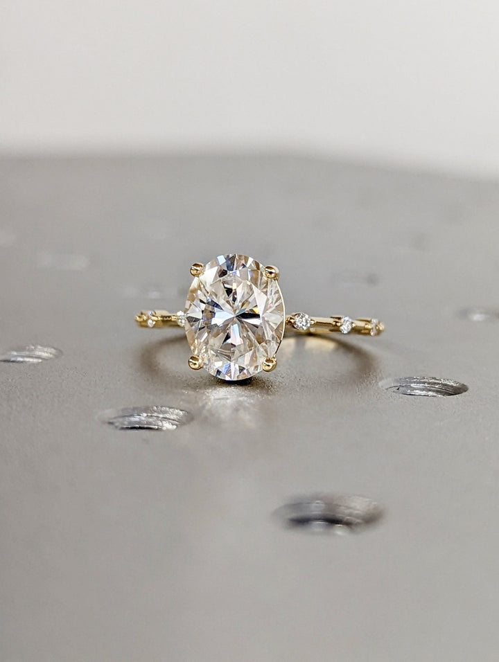 Elegant oval diamond proposal ring with sparkling accents