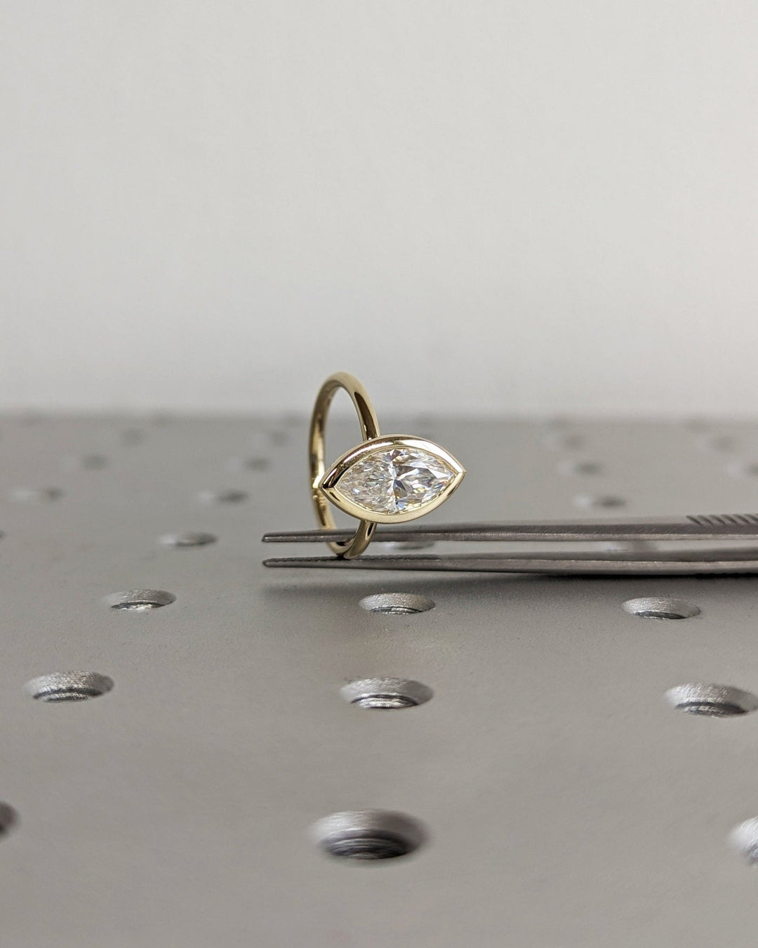 Marquise shaped engagement ring with secure bezel mount
