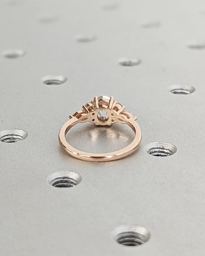 Lab grown diamond engagement ring featuring oval cluster setting
