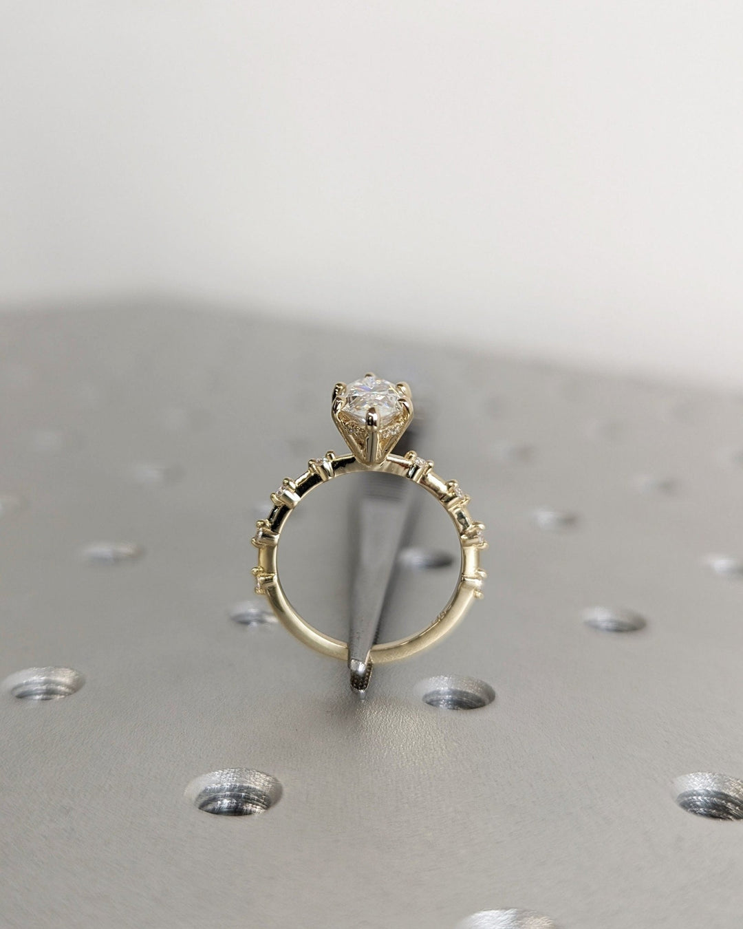 Modern hidden halo engagement ring featuring marquise diamond