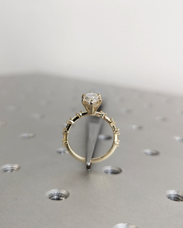 Modern hidden halo engagement ring featuring marquise diamond