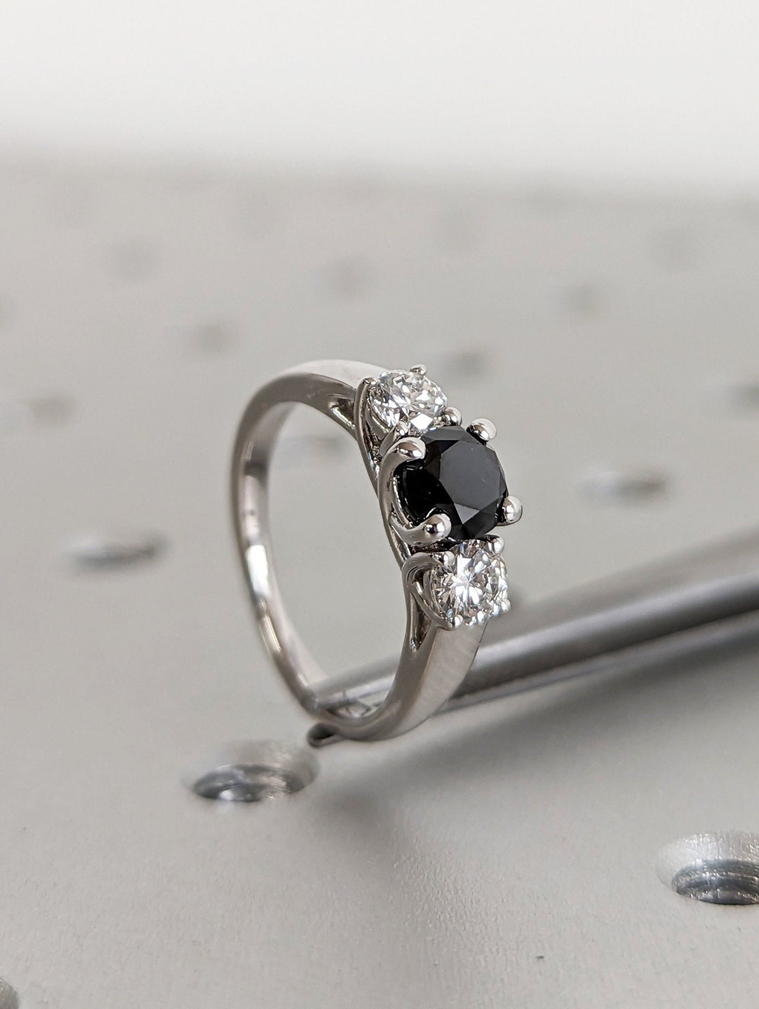 Sophisticated proposal ring with black round center stone