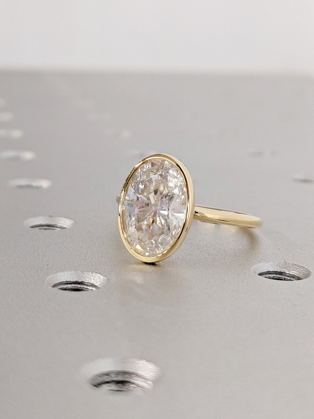 Oval cut diamond engagement ring with modern bezel setting