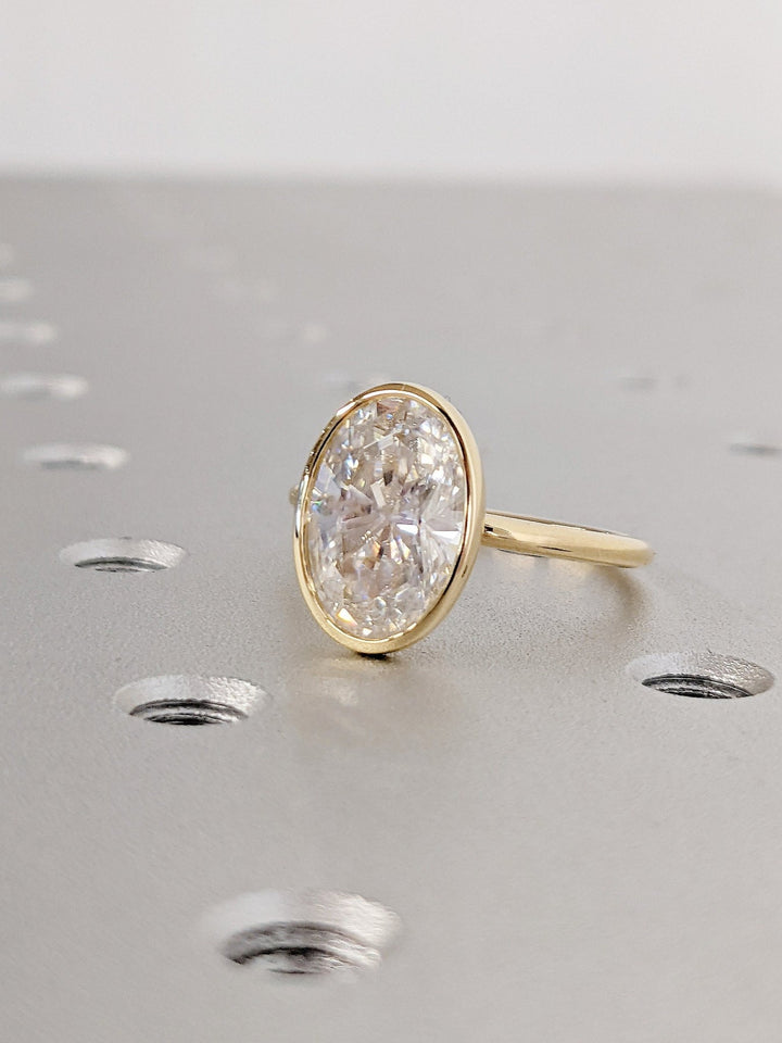Oval cut diamond engagement ring with modern bezel setting