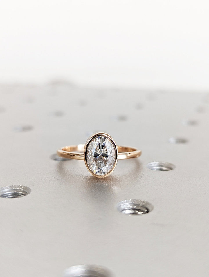1.50 carat oval cut bezel lab grown diamond engagement ring
