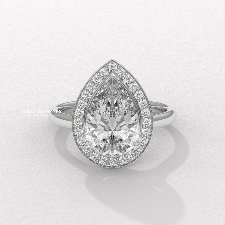 Pear cut rose gold halo ring
Pear diamond ring with side stones
Pear diamond platinum ring