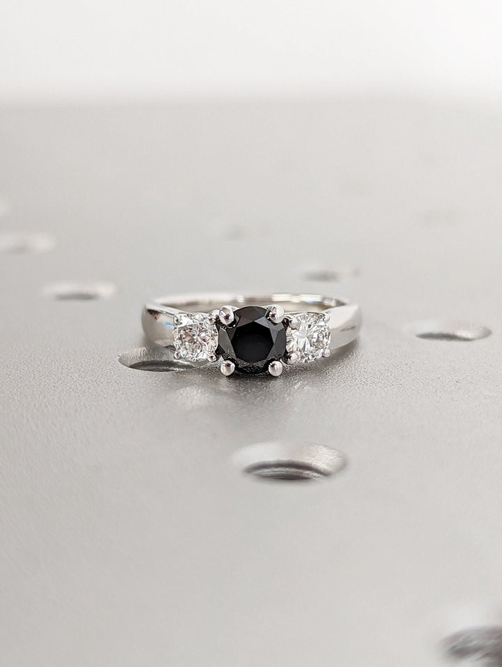 Sparkling diamond side stones with black round centerpiece
Modern black diamond engagement ring for women