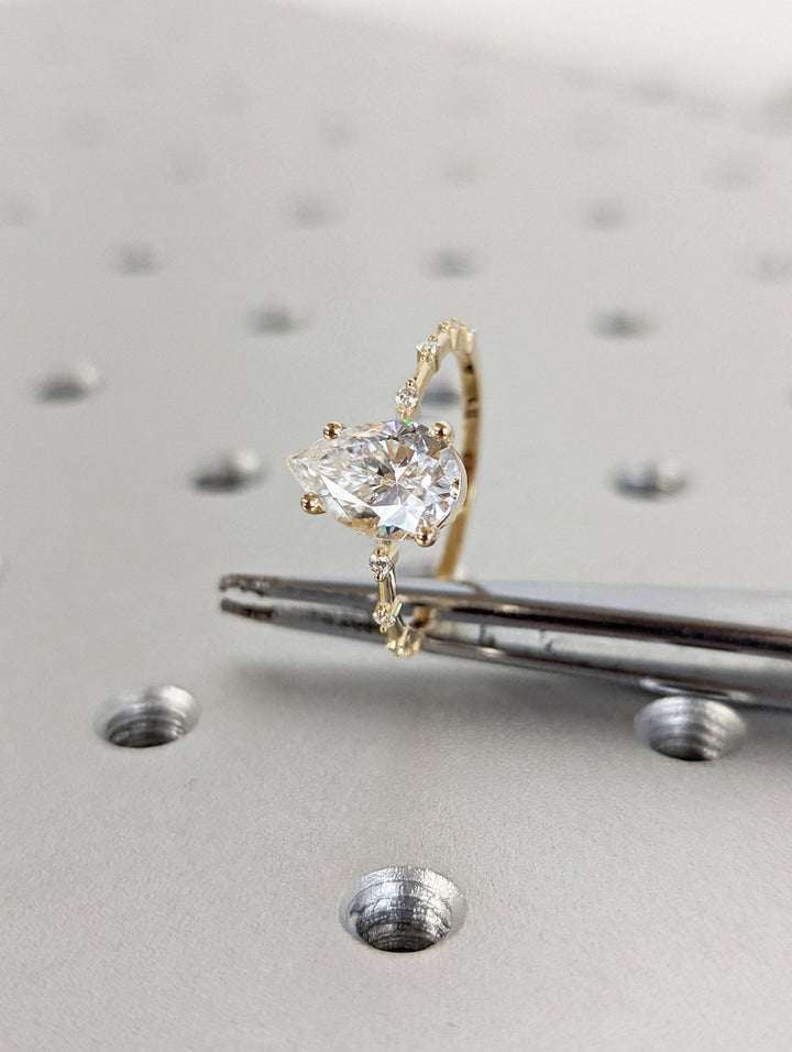 Timeless pear shaped engagement ring with delicate sparkle