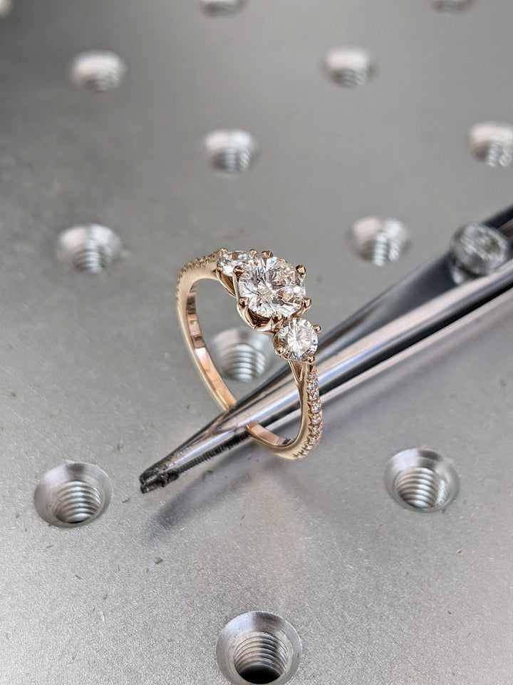 Timeless three stone engagement ring with round diamonds