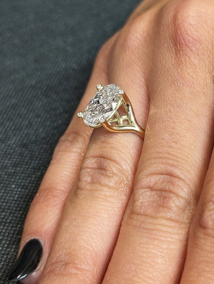 Elegant bridal ring with oval diamond centerpiece
