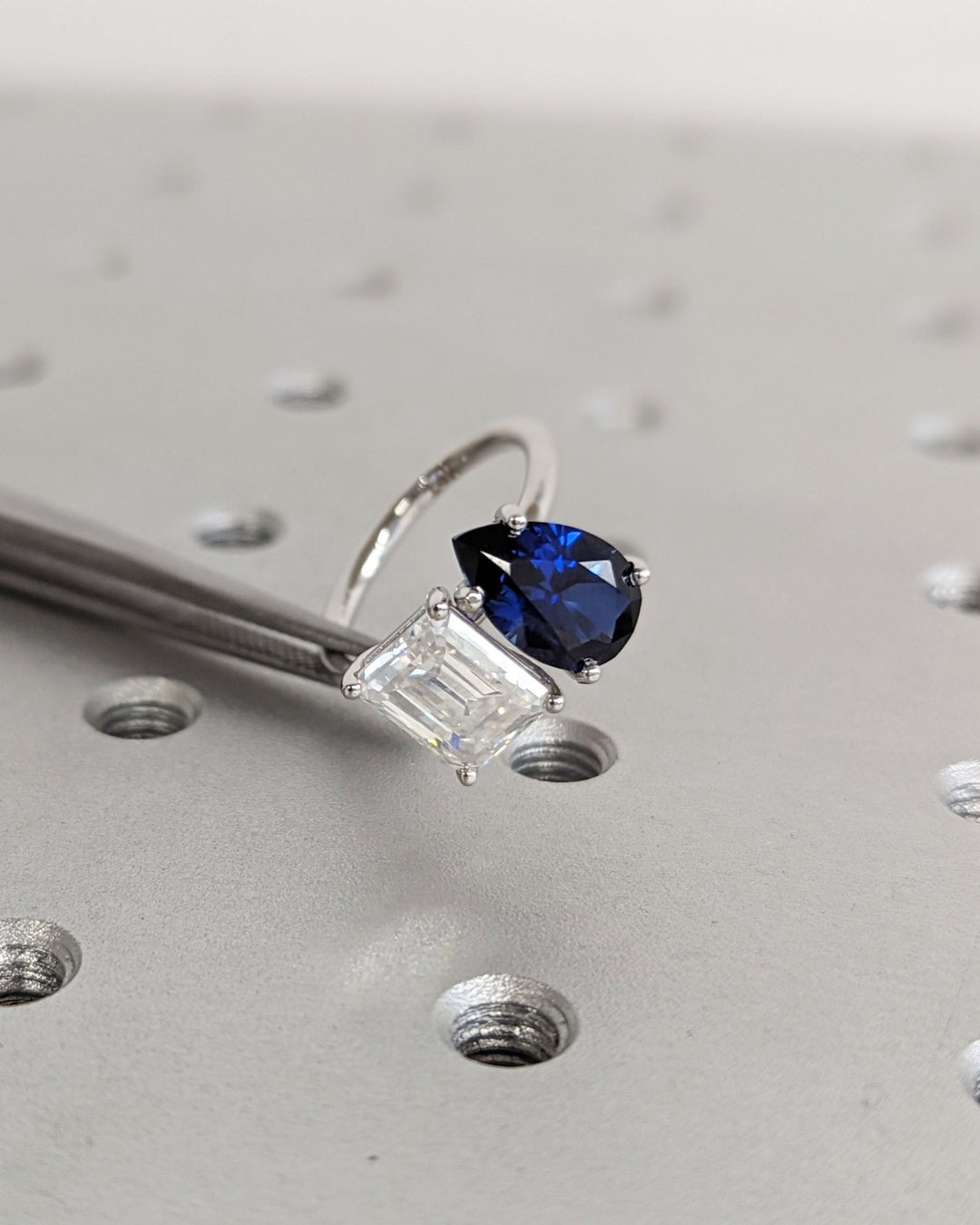 Elegant sapphire and emerald cut two stone engagement ring