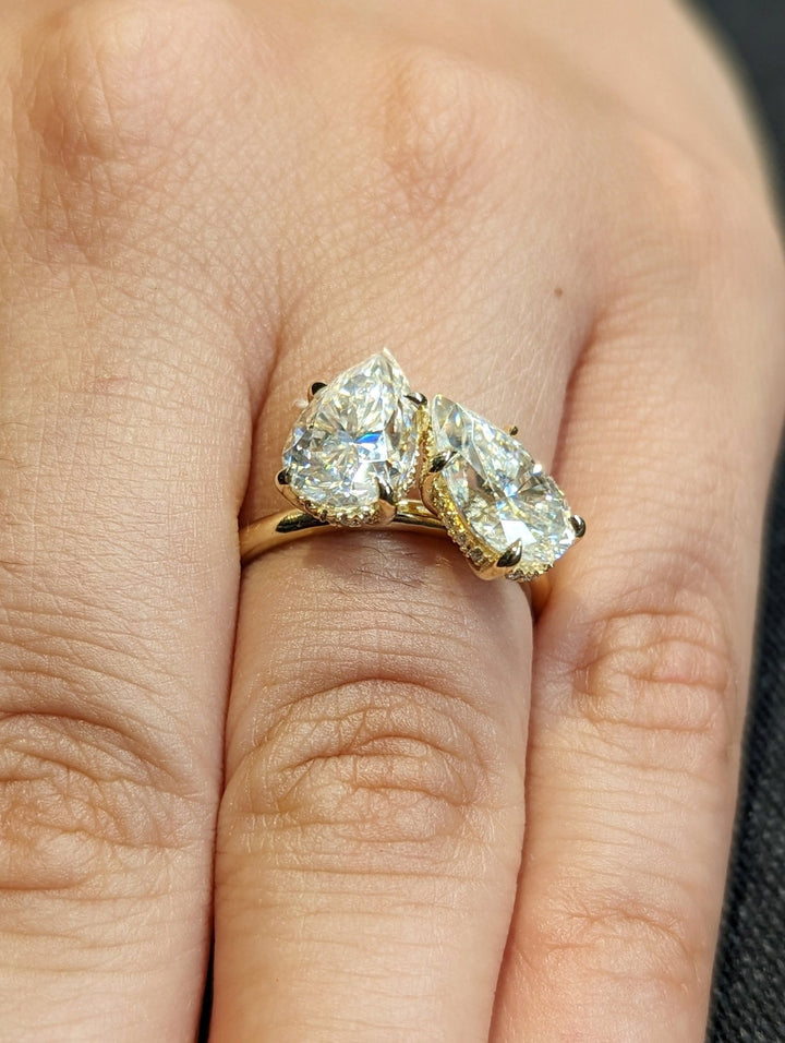 Sparkling pear diamond ring with concealed halo accents