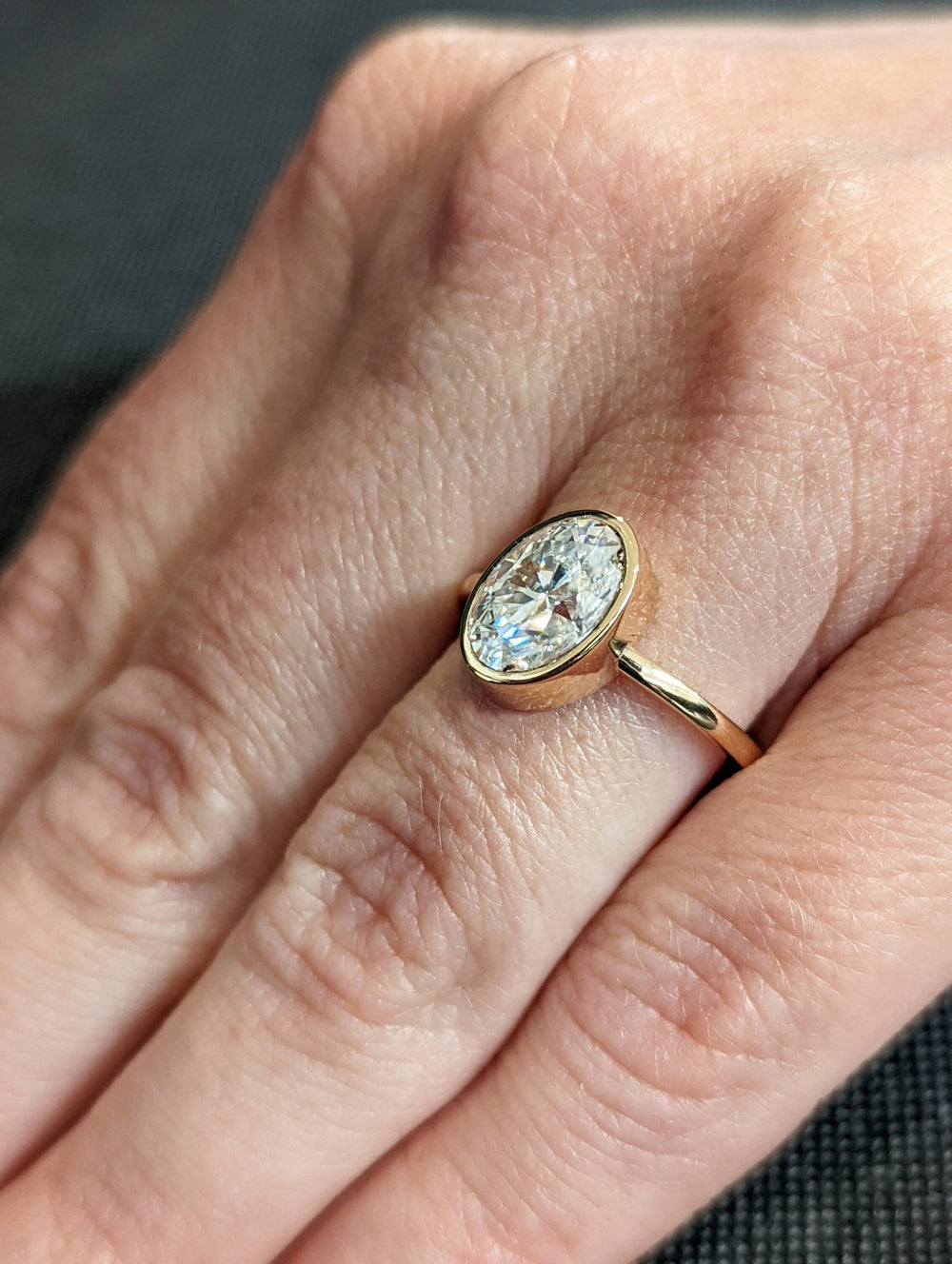 Oval cut diamond ring with modern bezel setting
