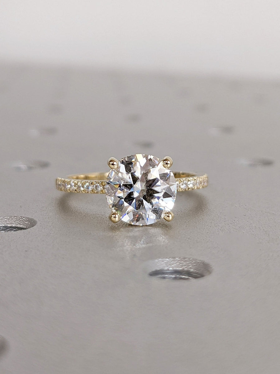 Brilliant round cut engagement ring with sparkling pave setting
