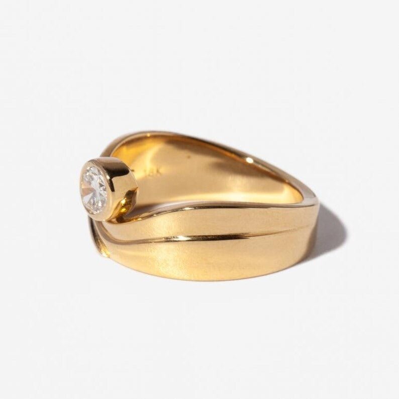 bezel engagement ring, bezel set diamond ring, oval bezel ring, wave engagement ring, wave design ring, curved engagement ring, modern engagement ring, contemporary engagement ring, designer engagement ring, elegant engagement ring, timeless engagement ring,