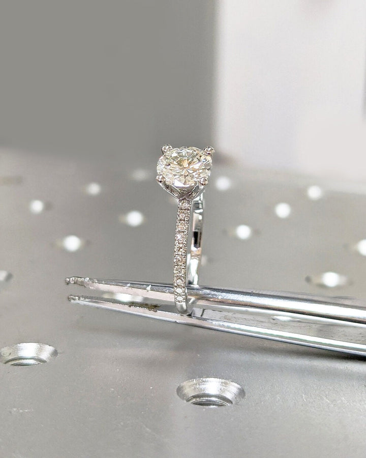 round cut engagement ring with side diamonds,