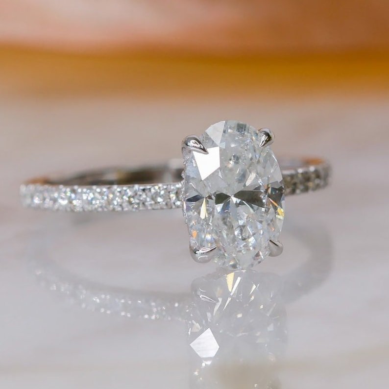 Side angle of oval hidden halo diamond engagement ring