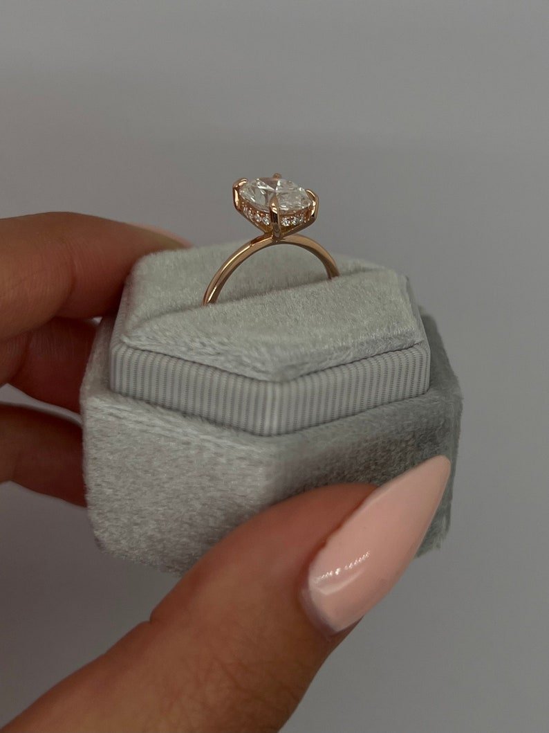 oval hidden halo solitaire ring