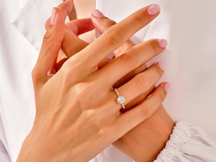 Detailed close-up of round pave diamond engagement ring