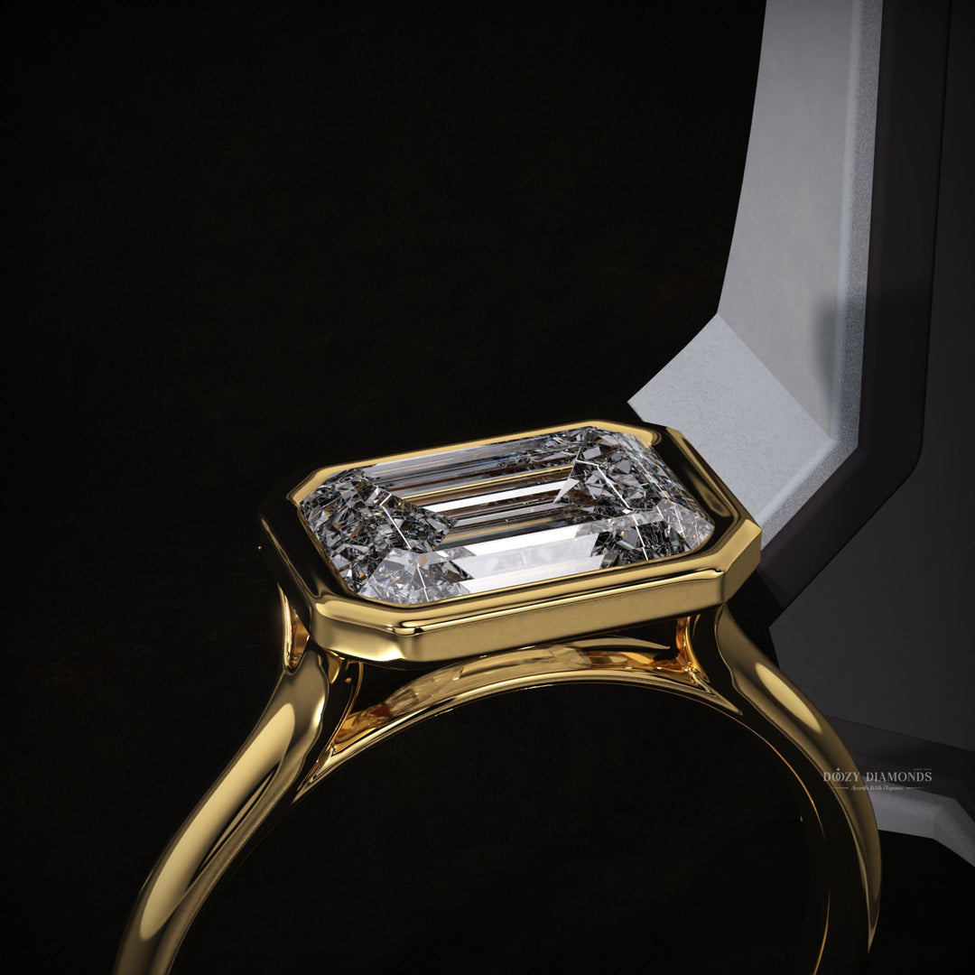 east west engagement ring
sustainable diamond ring
eco friendly engagement ring
ethical diamond ring
bezel set diamond ring
emerald cut lab diamond