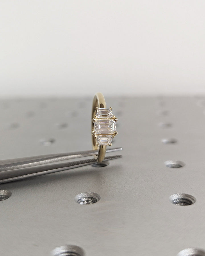 classic emerald cut three stone ring