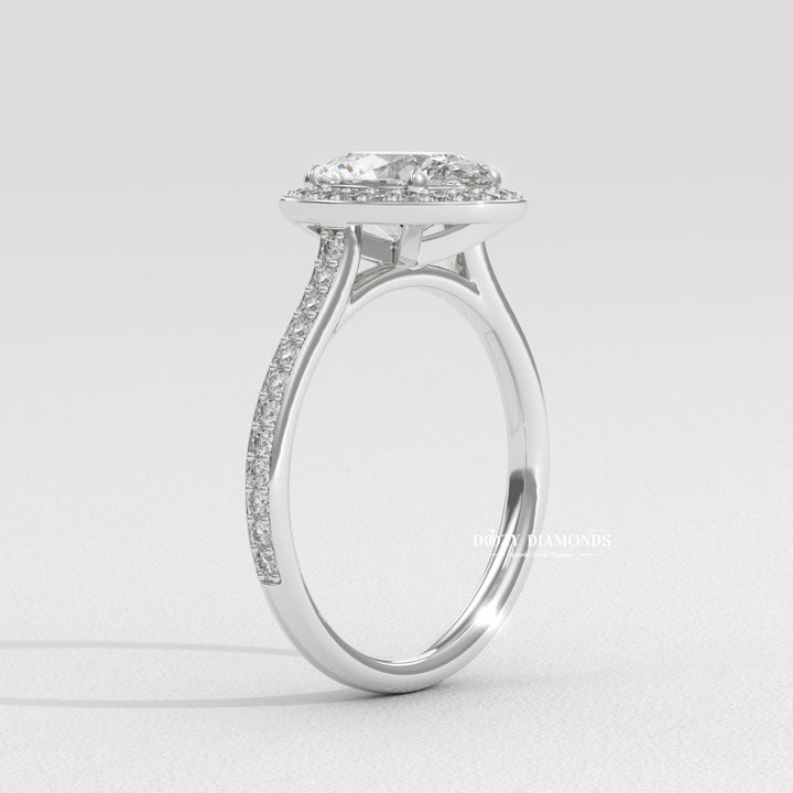 classic halo engagement ring, oval lab diamond ring, oval diamond bridal ring, channel halo ring, luxury halo diamond ring, diamond proposal ring, sustainable bridal ring, ethical lab diamond ring, oval cut lab diamond ring, halo wedding ring, fine jewelry engagement ring, dazzling halo ring,