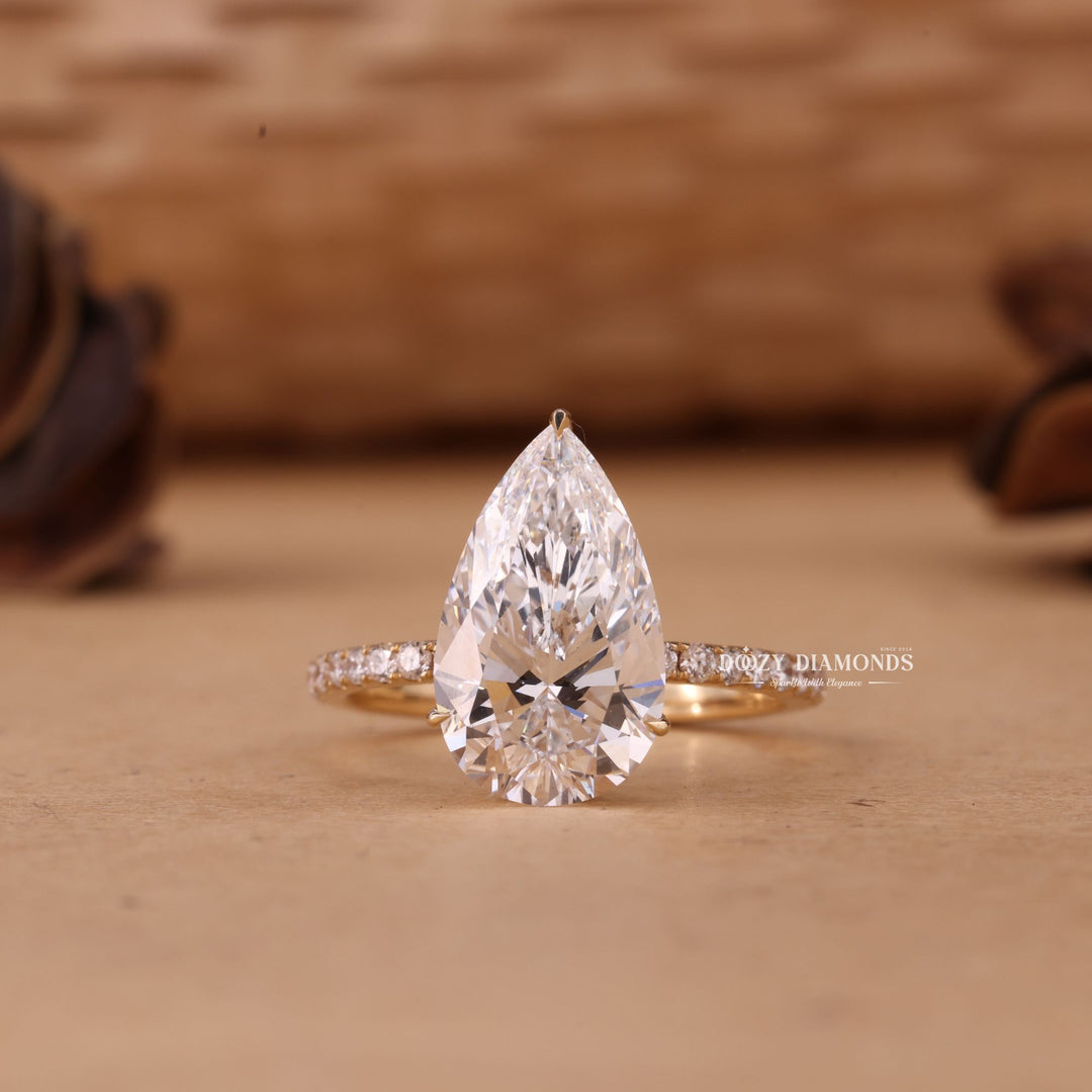 Shop a 5.0CT–7.0CT pear cut EF/VS1 lab grown diamond hidden halo engagement ring featuring exceptional brilliance, luxury craftsmanship, and sustainable beauty.