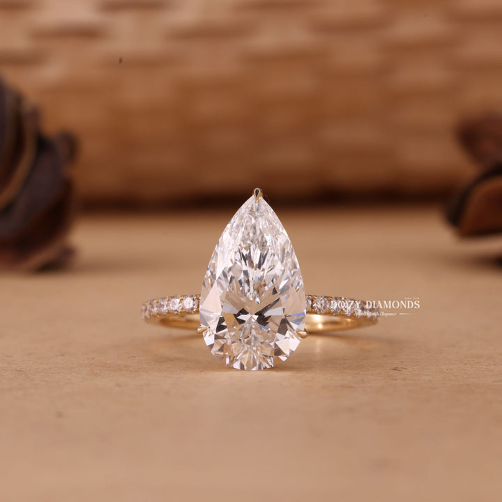 Shop a 5.0CT–7.0CT pear cut EF/VS1 lab grown diamond hidden halo engagement ring featuring exceptional brilliance, luxury craftsmanship, and sustainable beauty.