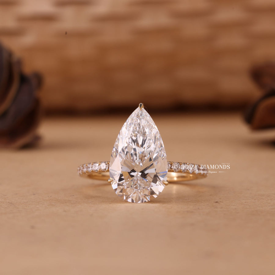 Shop a 5.0CT–7.0CT pear cut EF/VS1 lab grown diamond hidden halo engagement ring featuring exceptional brilliance, luxury craftsmanship, and sustainable beauty.