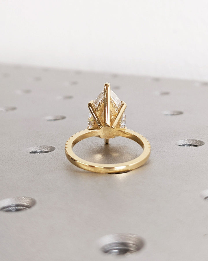 pear cut engagement ring with accent diamonds,