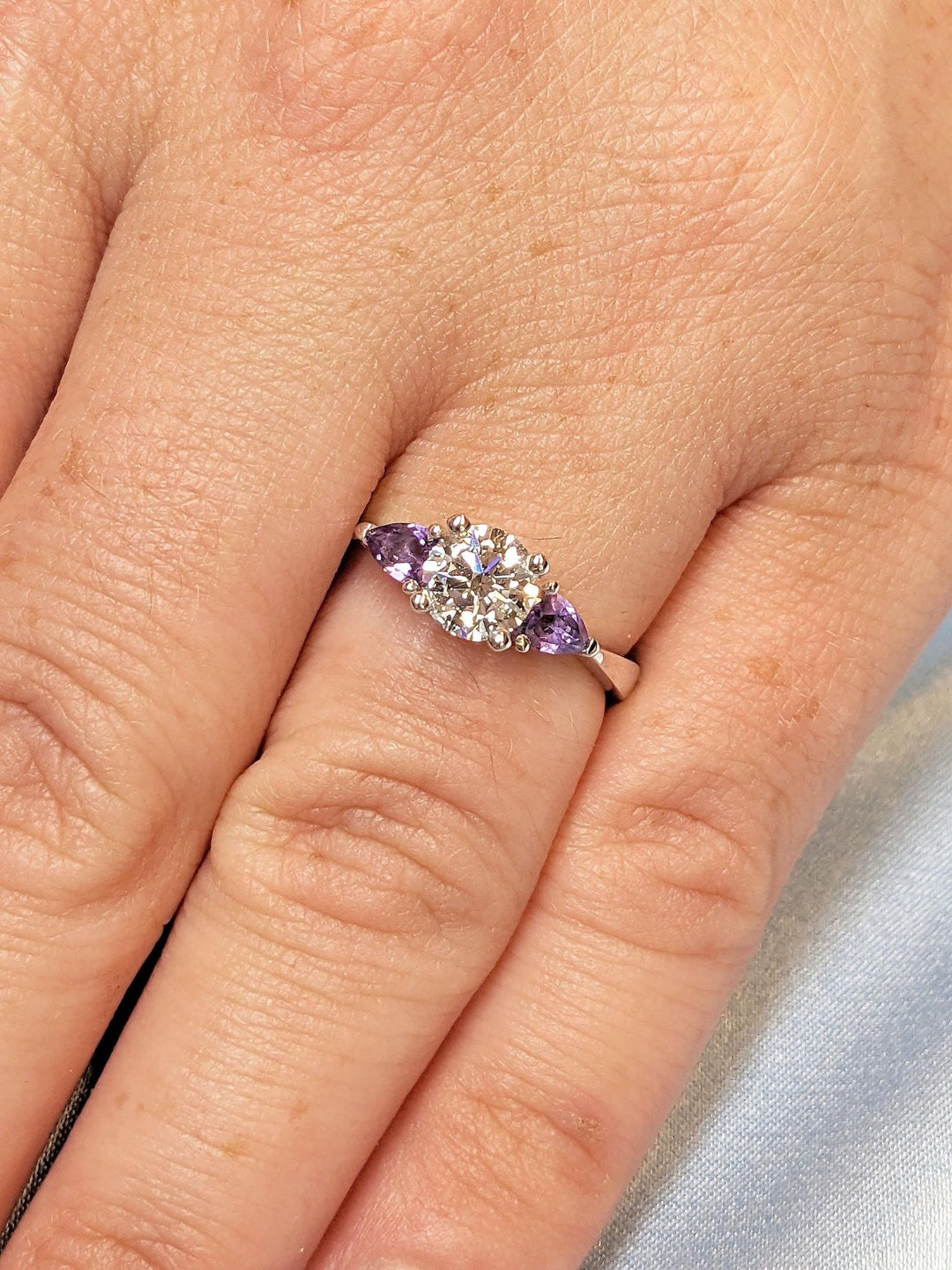 emerald cut engagement ring with cluster diamonds
