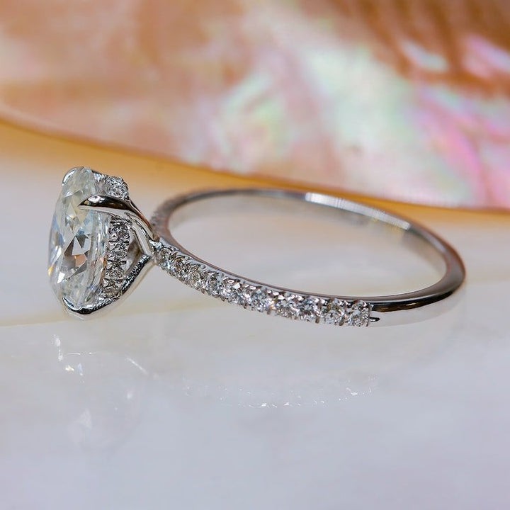 Profile view of oval cut hidden halo engagement ring band