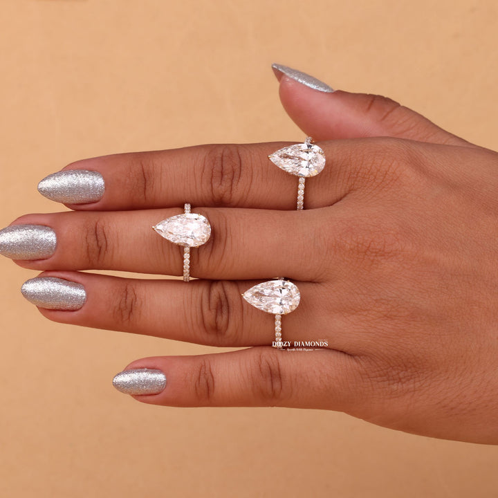 ring relationship symbol, romantic diamond proposal ring, elegant wedding proposal ring, signature bridal jewelry, luxury engagement centerpiece, pear bridal ring, glamorous hidden halo ring,
