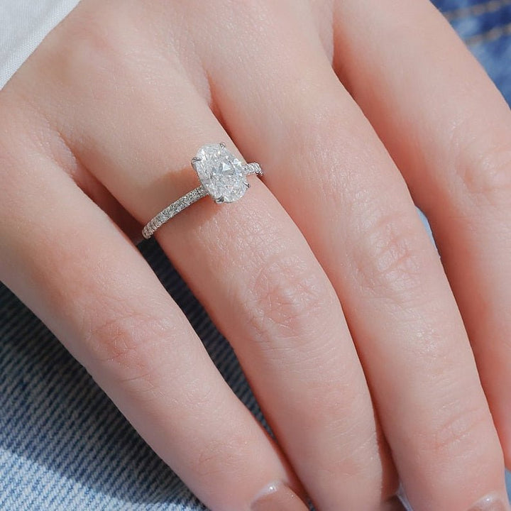 Lifestyle shot of oval hidden halo diamond ring on hand