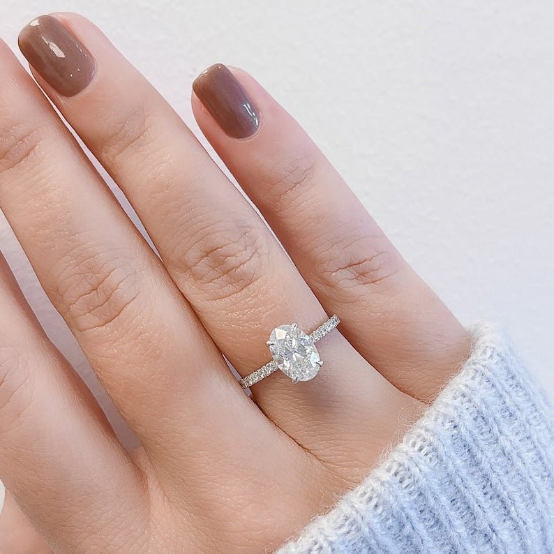 Oval cut hidden halo engagement ring shown in real-life wear
